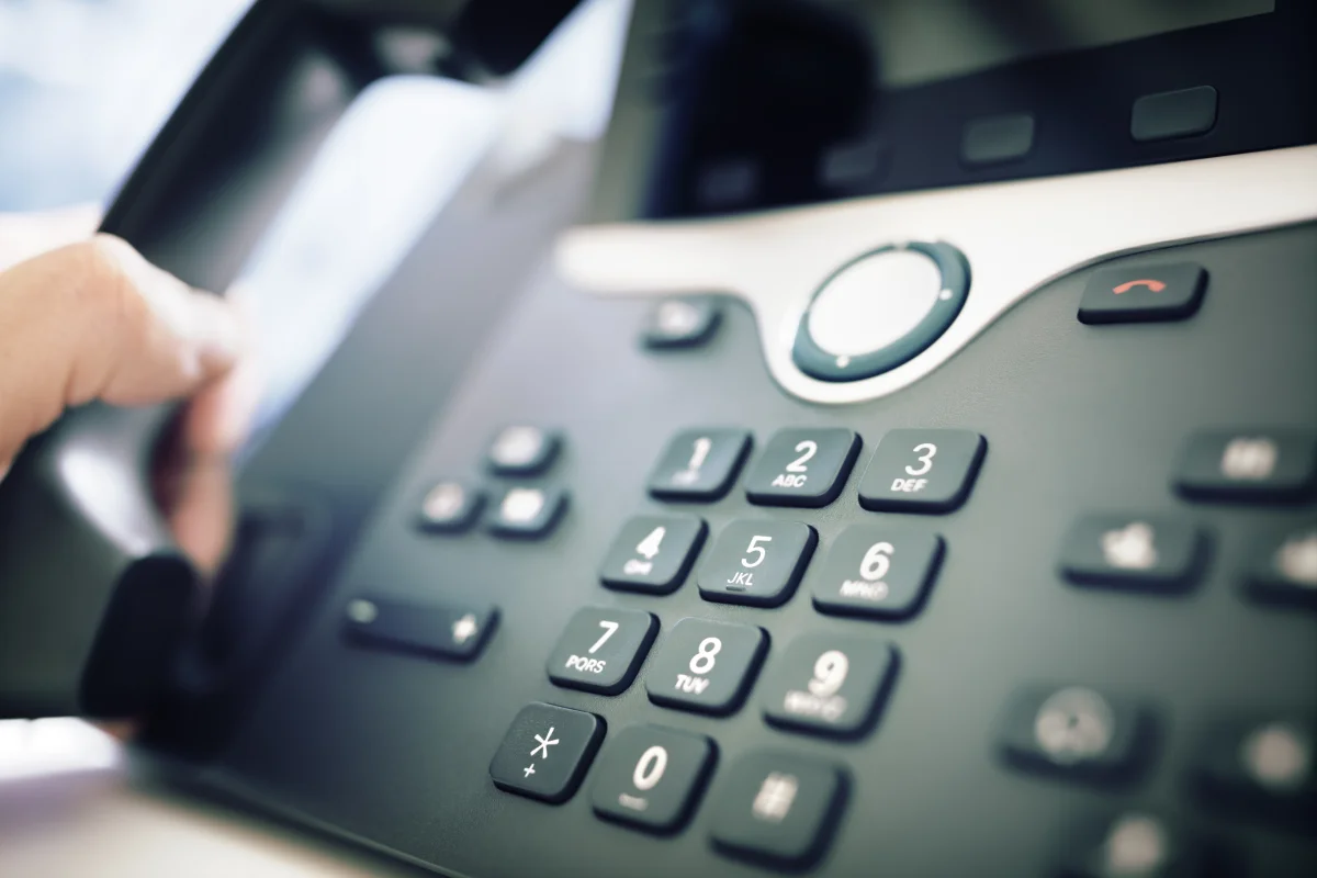 Business professional using modern phone system